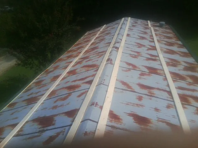 Rusted metal roof panels with new wood purlins before replacement — Storm Damage Roof Repair in York Springs by Roofing Brothers