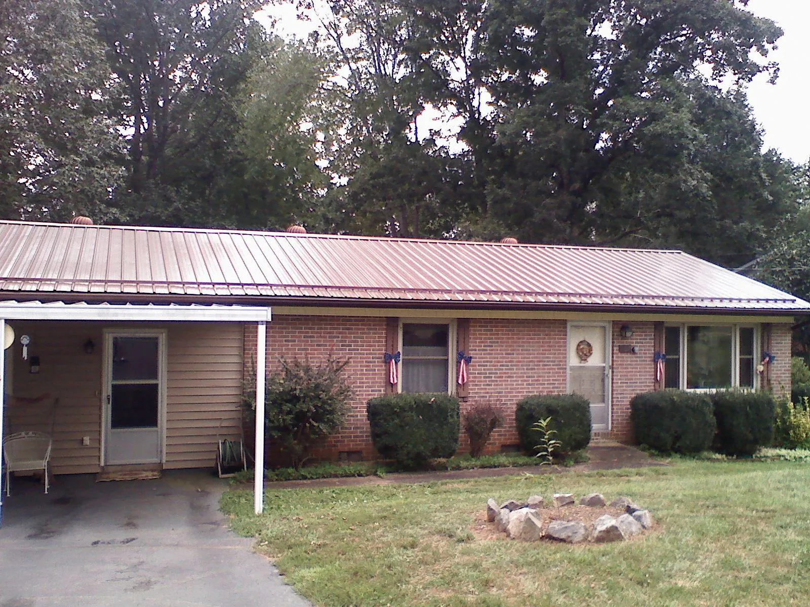 Bronze metal roof and carport on a brick ranch home — Roof Repair work by our crew in York Springs